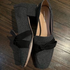 Gently worn gray loafer with black bow. Has a low heel.